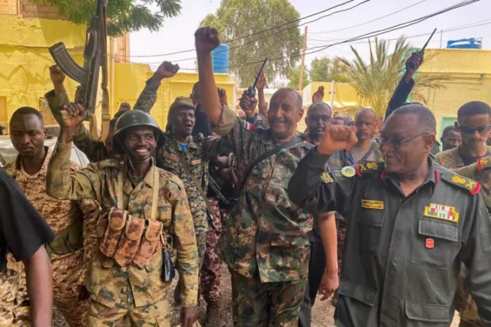 Army chief Abdel Fattah al-Burhan cheers on soldiers as he visits some of their positions in Khartoum [Sudanese Army’s Facebook page via AFP]